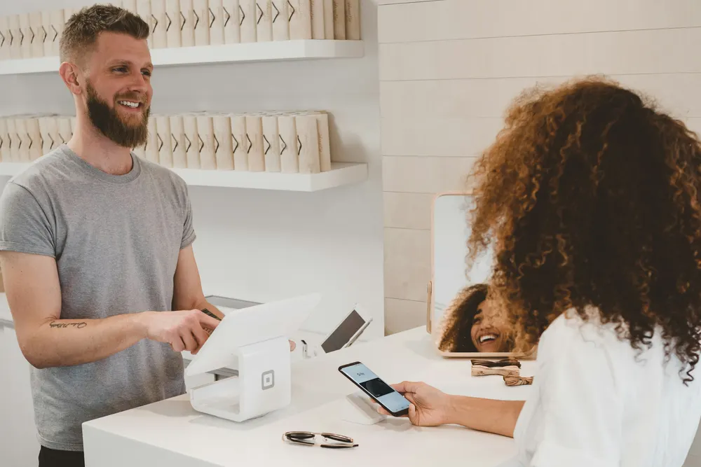 Small business owner helping a customer at the counter