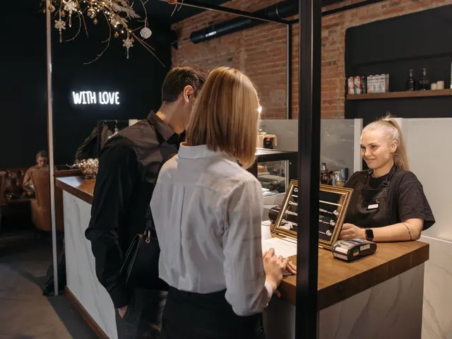 Barista serving customers at a local cafe counter