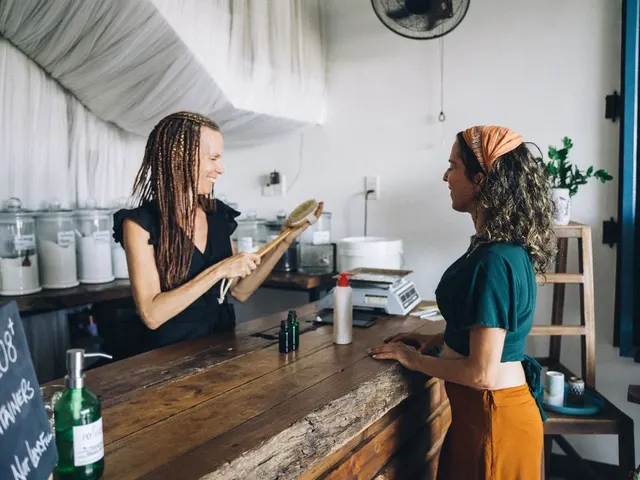 Shop owner helping a customer at the counter